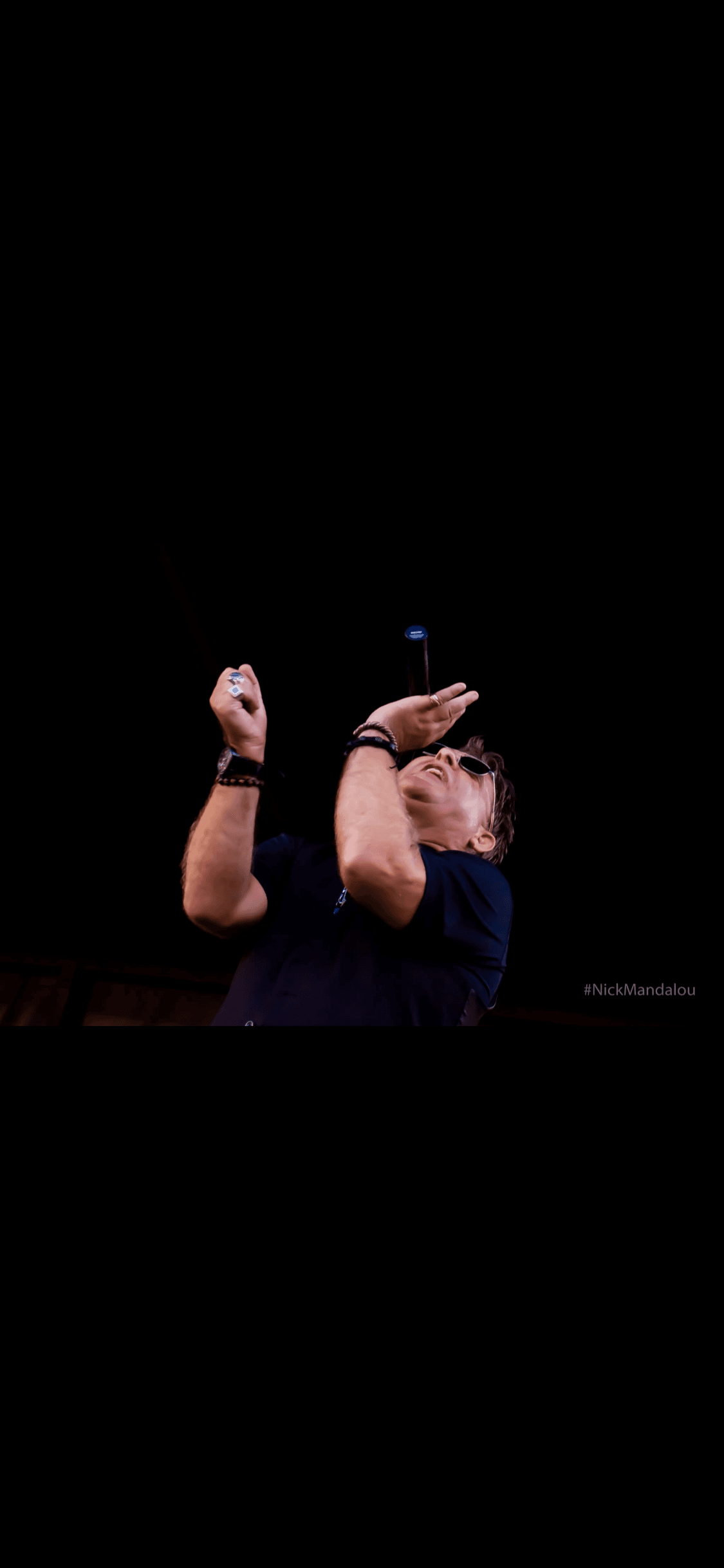 JC Grigg performing live with dramatic stage lighting
