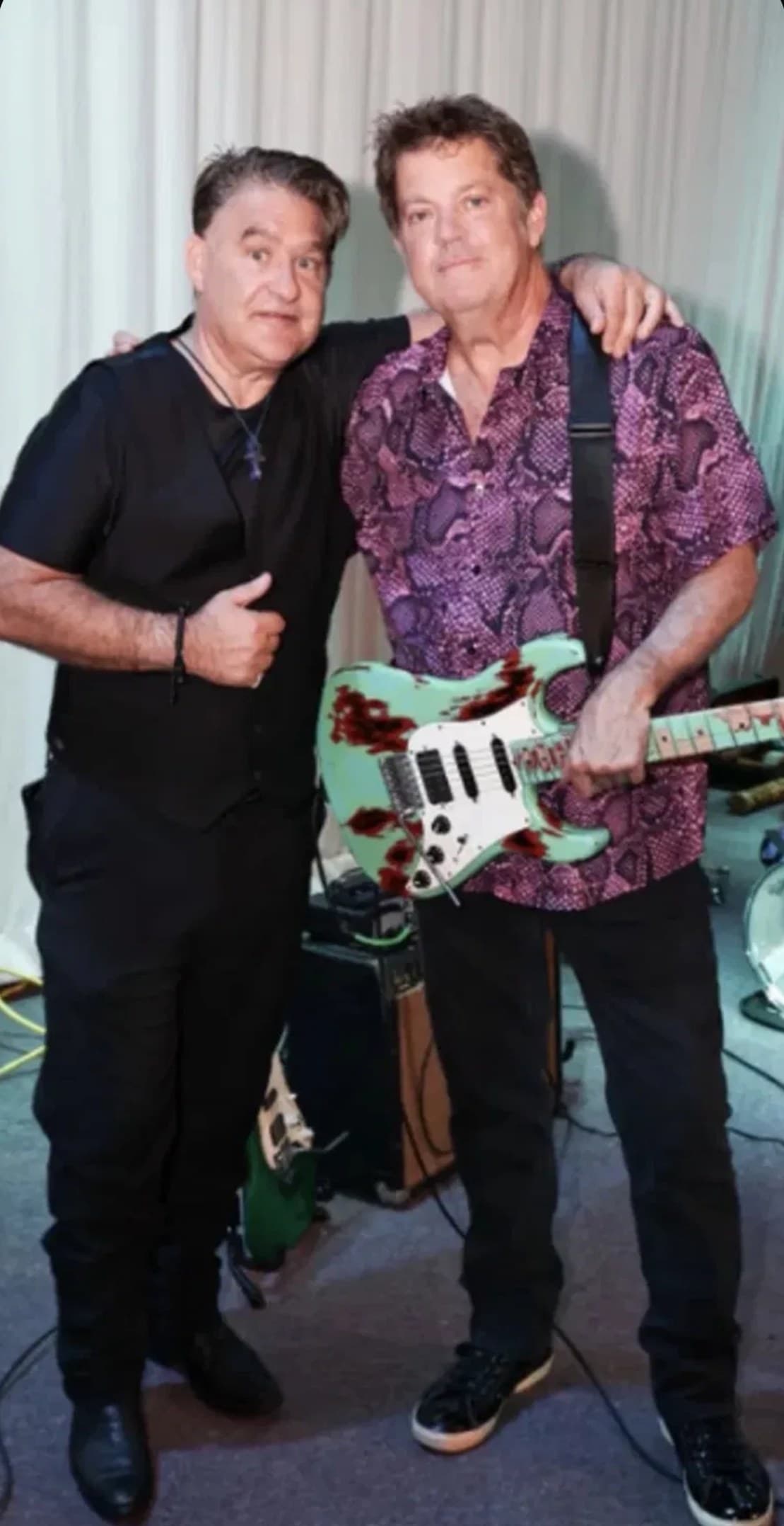 J.C. Grigg giving a thumbs up beside guitarist Keith Howland
