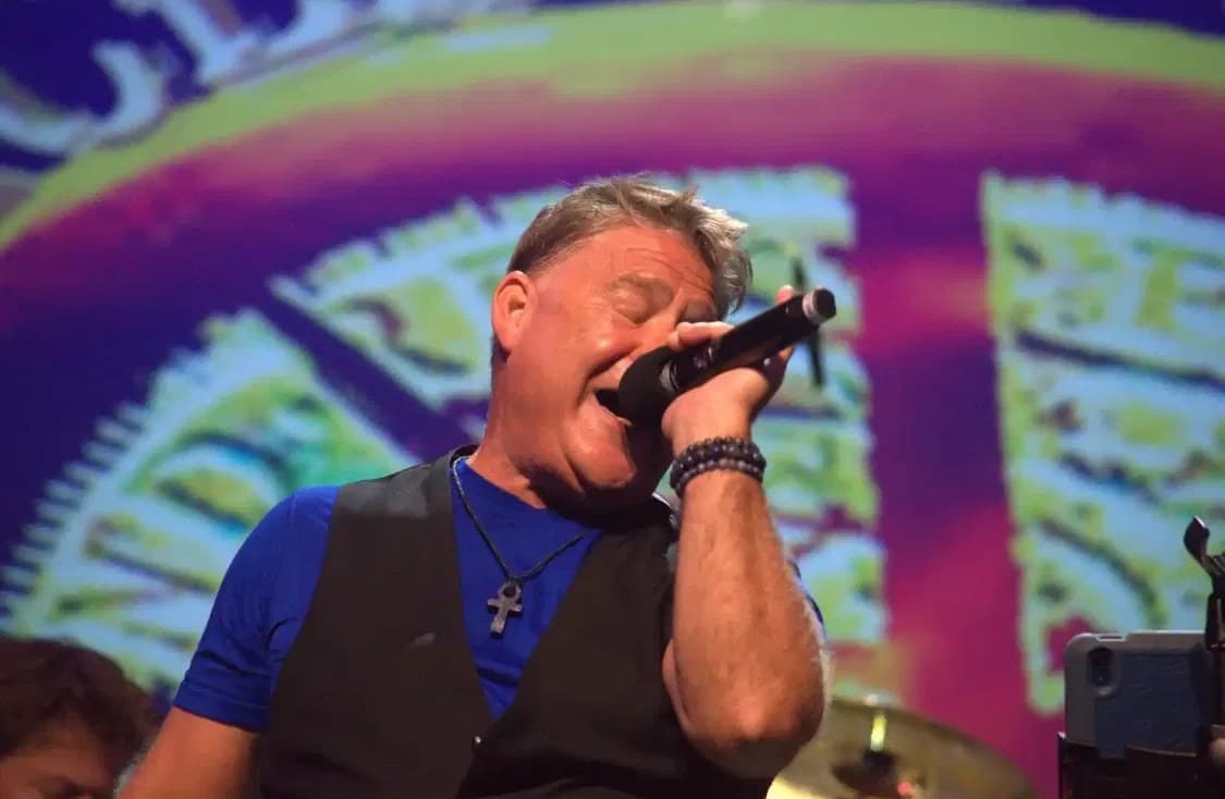 J.C. Grigg singing live into a microphone