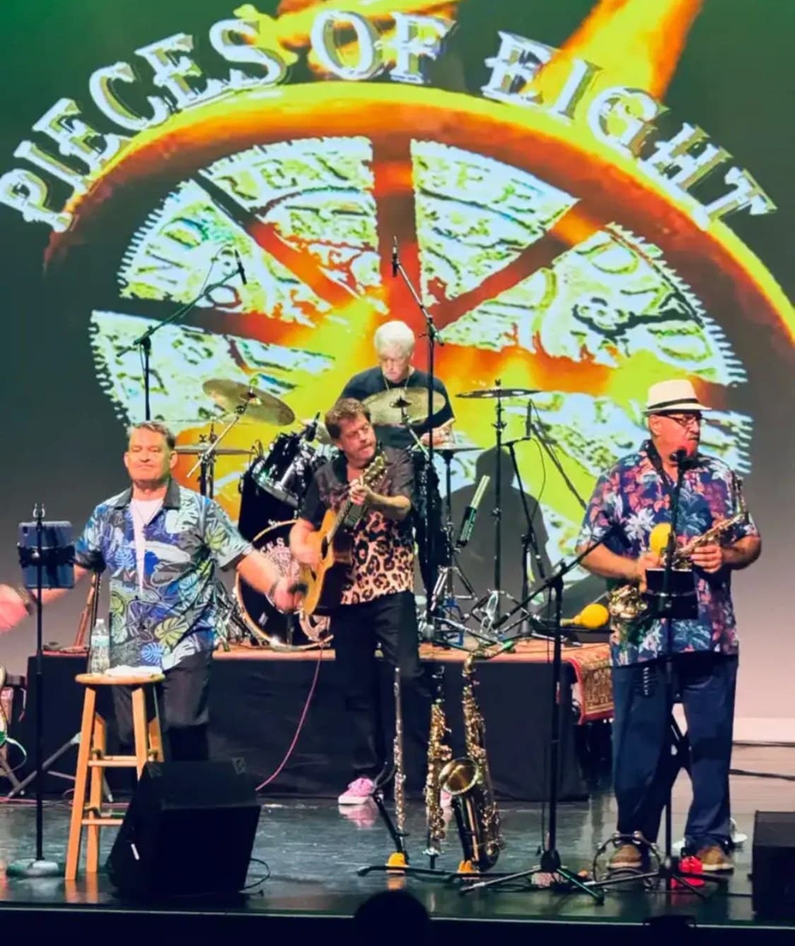 Pieces of Eight performing live onstage in front of the band logo