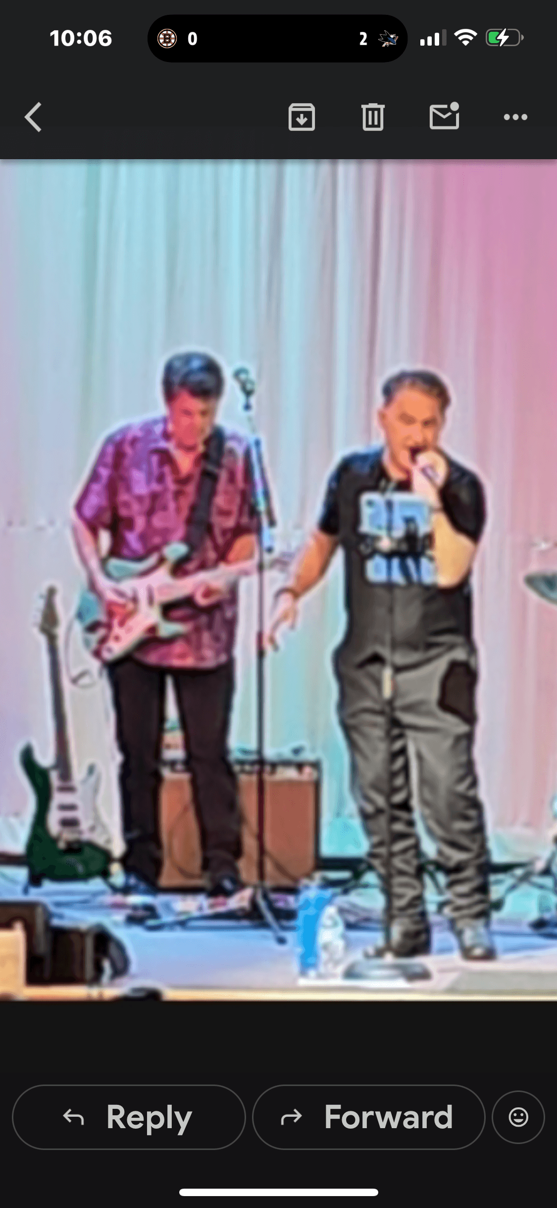 JC Grigg and band performing live under colorful stage lights