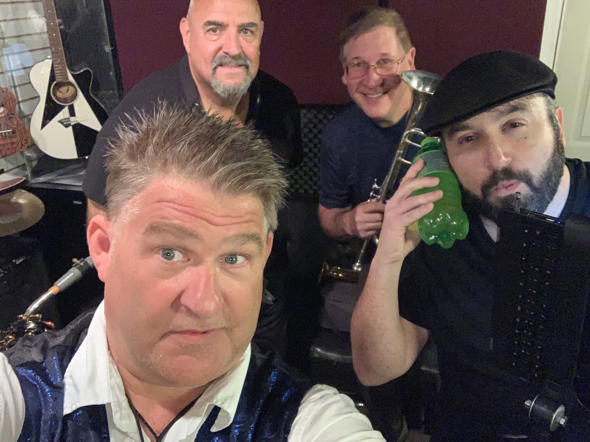 Pieces of Eight Chicago tribute band from Tampa - group selfie of band members with instruments